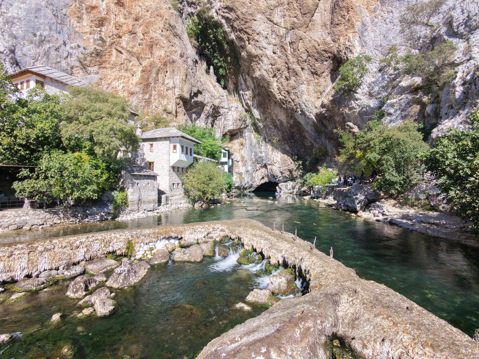 Blagaj Tekke by the Buna spring beneath a high cliff